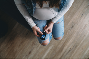 Pregnant woman checking blood sugar